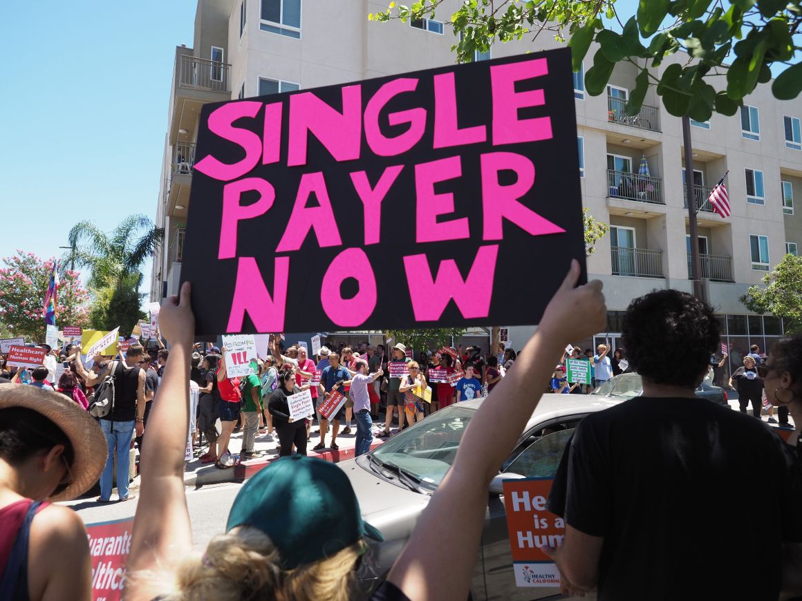 People rally in favor of single-payer health care outside of the office of Speaker of the California State Assembly Anthony Rendon on June 27th, 2017, in South Gate, California.