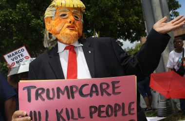 A man dressed as Donald Trump at a Florida protest against the Senate's 2017 health-care bill, which proposed drastic Medicaid cuts.