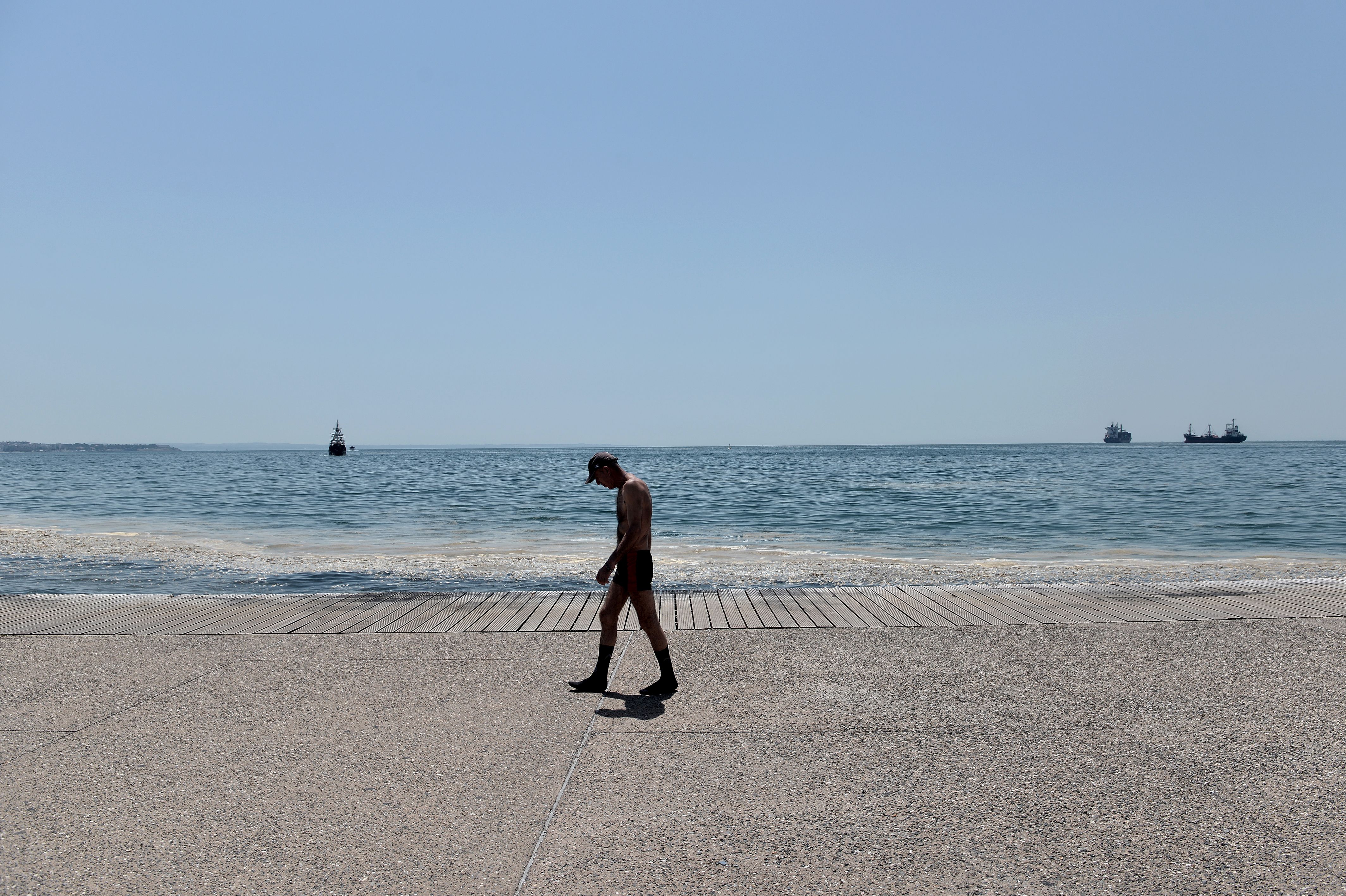 A man walks along the seaside promenade in Thessaloniki on June 29th, 2017, when temperatures there were expected to reach up to 43 degrees Celsius.