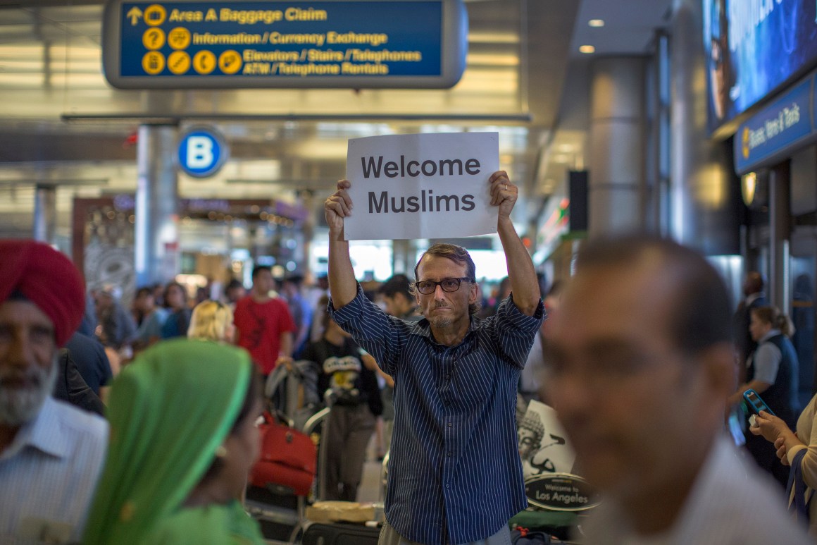 A man carries a sign welcoming Sikh travelers at Los Angeles International Airport on June 29th, 2017, in Los Angeles, California.