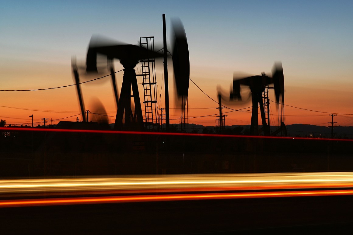 Car lights streak past an oil rig in Culver City, California.