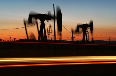 Car lights streak past an oil rig in Culver City, California.