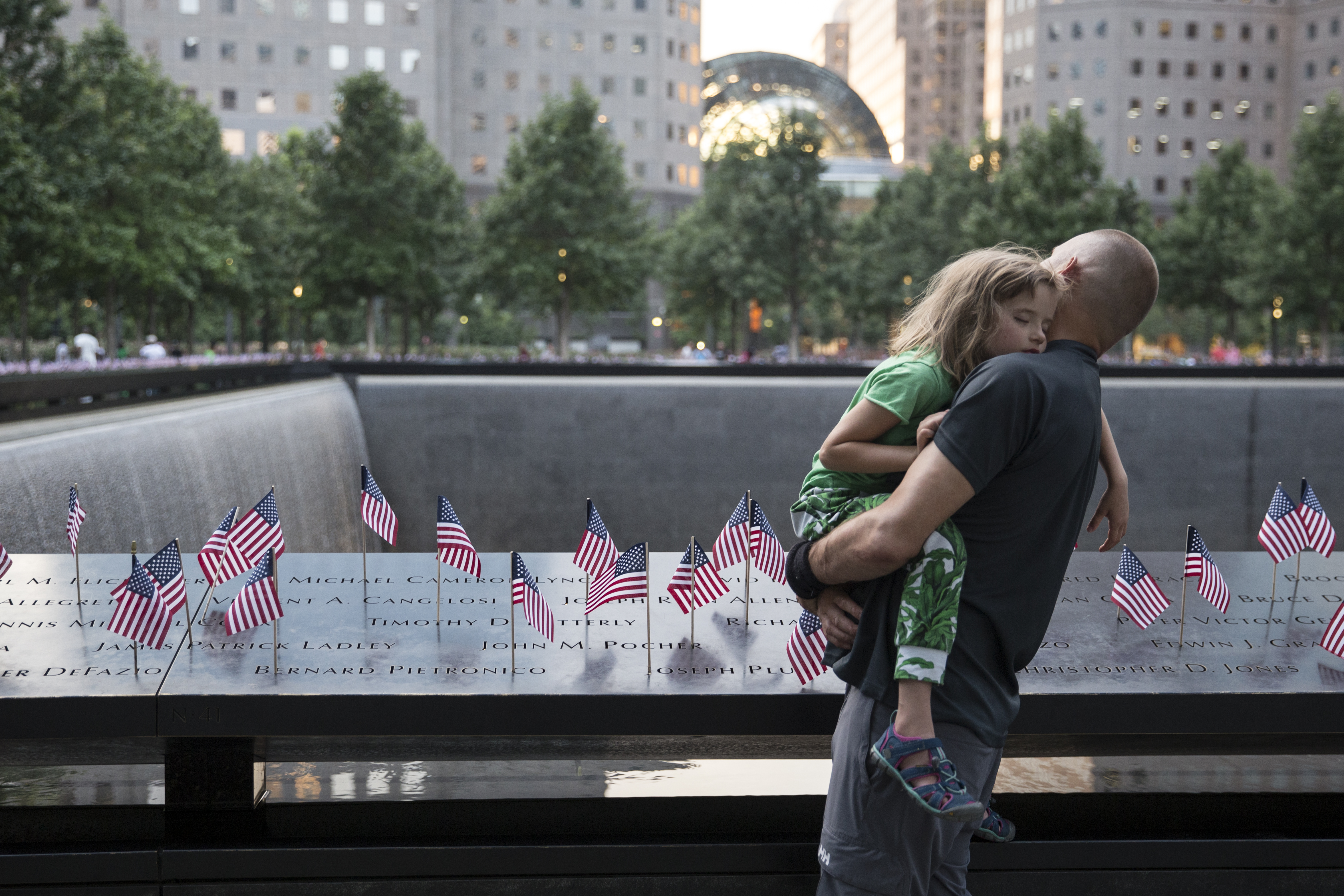 Small American flags are placed in all 2,983 names on the 9/11 Memorial on July 4th, 2017, in New York City.