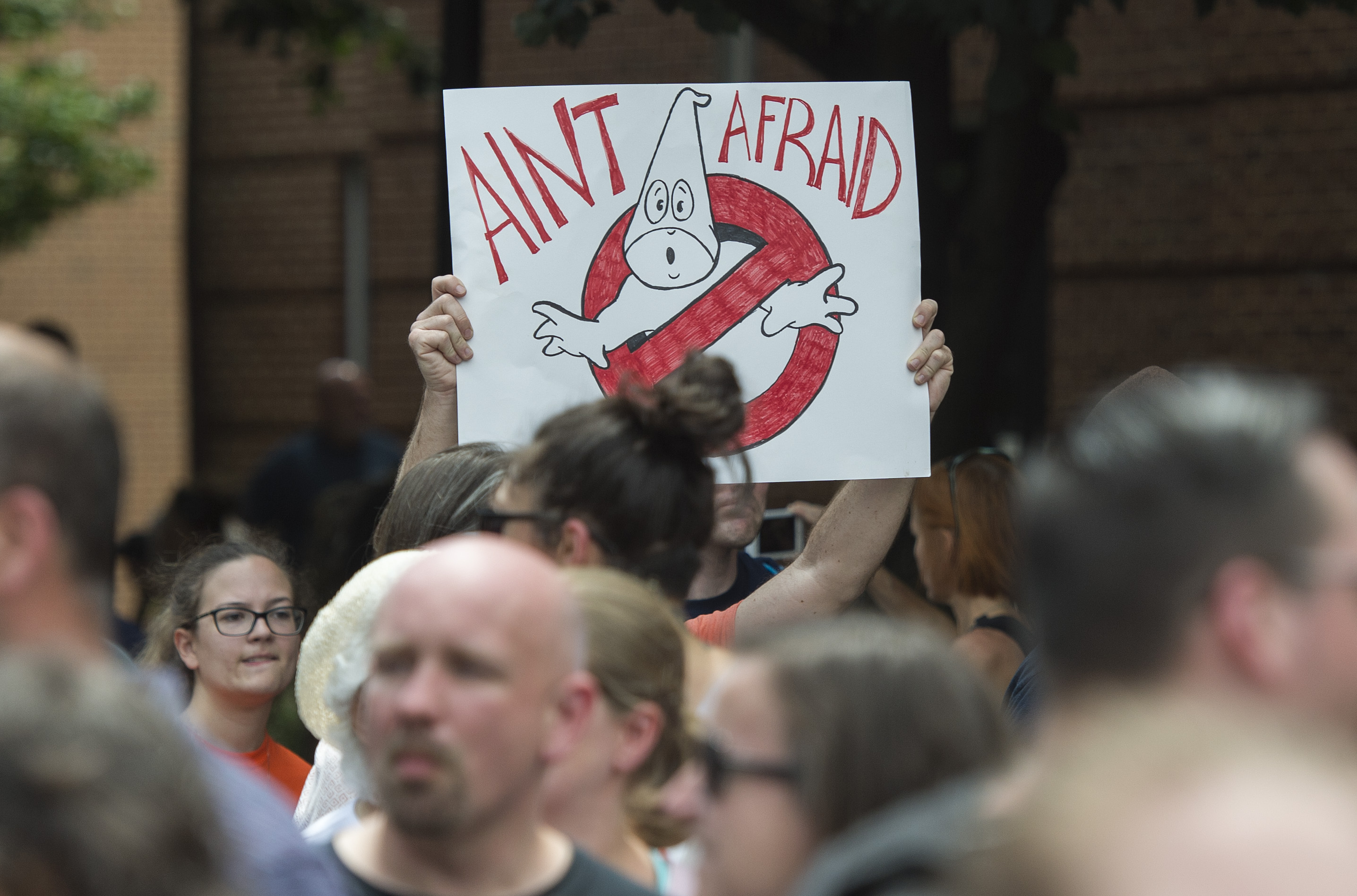 A counter-protester holds up a sign before a rally in Charlottesville, Virginia.