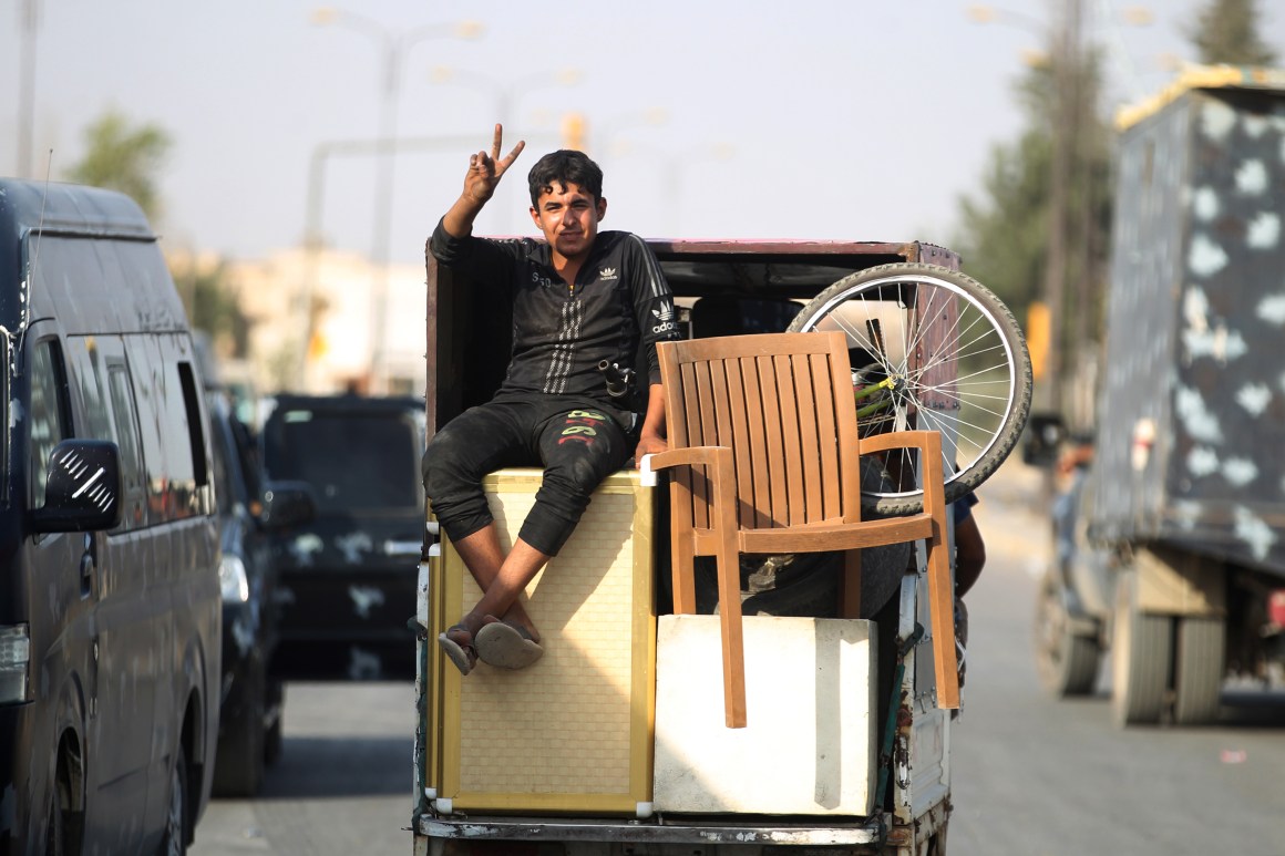 An Iraqi boy flashes the sign for victory as he celebrates in the Old City of Mosul on July 9th, 2017, after the government's announcement of the liberation of the embattled city.