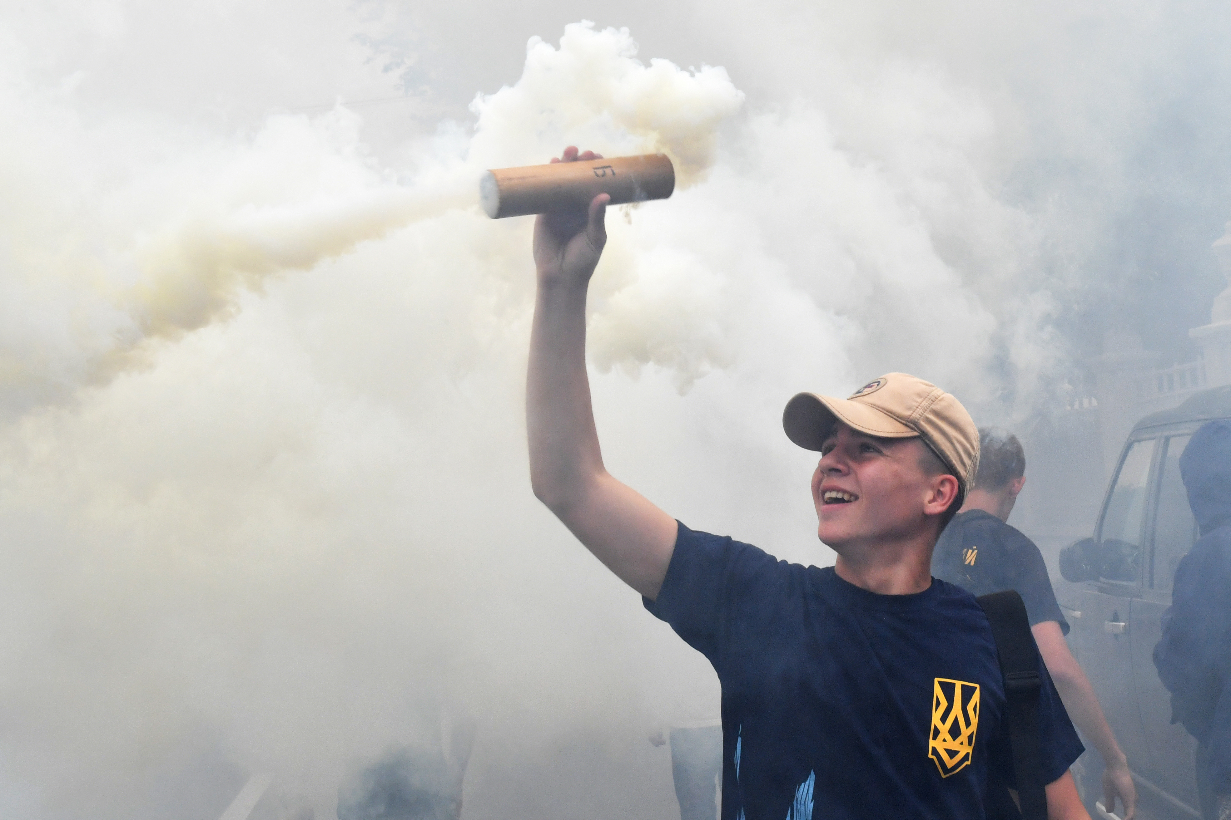 An activist holds up a flare during a protest in front of Ukrainian Parliament in Kiev on July 11th, 2017, demanding the removal of immunity for deputies. The parliament of Ukraine is debating the submission by the general prosecutor's office on the removal of parliamentary immunity from five parliamentarians suspected of corruption.