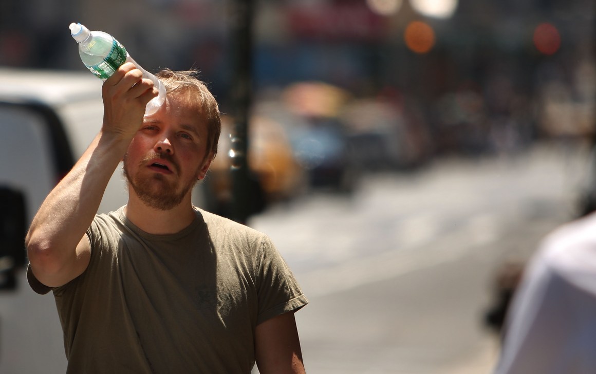 A man tries to cool himself with a bottle of water during a heat wave on June 9th, 2008, in New York City.