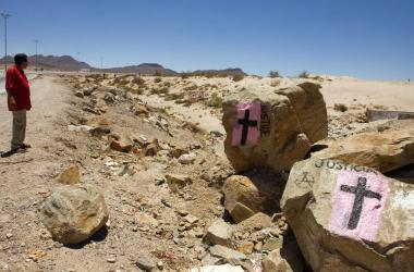 A man looks at rocks painted with crosses calling for justice, in allusion to deaths resulting from drug cartels' struggle for control in Ciudad Juarez, Mexico, on May 28th, 2008.