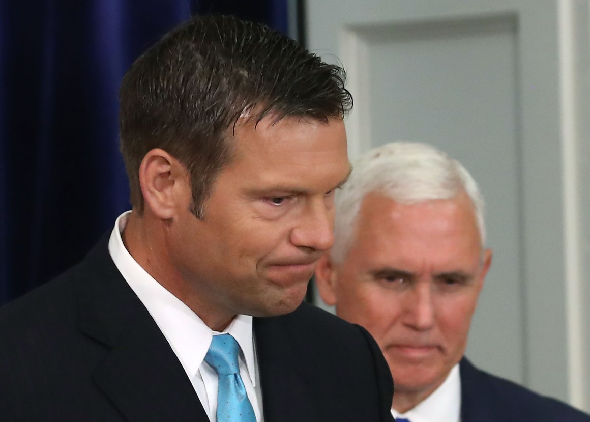 Kansas Secretary of State Kris Kobach (L) and U.S. Vice President Mike Pence attend the first meeting of the Presidential Advisory Commission on Election Integrity in the Eisenhower Executive Office Building.