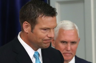 Kansas Secretary of State Kris Kobach (L) and U.S. Vice President Mike Pence attend the first meeting of the Presidential Advisory Commission on Election Integrity in the Eisenhower Executive Office Building.