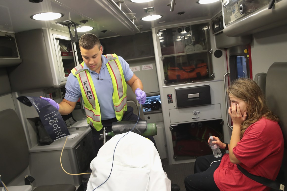 A firefighter treats a women suspected of overdosing on heroin on July 14th, 2017, in Rockford, Illinois.