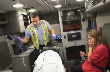 A firefighter treats a women suspected of overdosing on heroin on July 14th, 2017, in Rockford, Illinois.