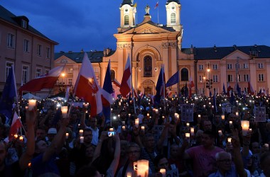 People hold candles and Polish national flags as they take part in a demonstration in front of the Polish Supreme Court on July 23rd, 2017, in Warsaw, Poland.