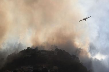 A fire-fighting Canadair aircraft flies to drop water over a fire near Carros, southeastern France, on July 24th, 2017.