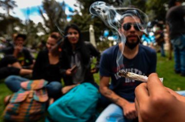 Activists smoke joints during a protest under the motto "No vamos a pagar, lo vamos a pegar" (translating to something like "We are not going to pay for it, we are going to get the kick out of it") against the imposing of fines for smoking marijuana by police according to their new code, in Bogota, on August 1st, 2017.