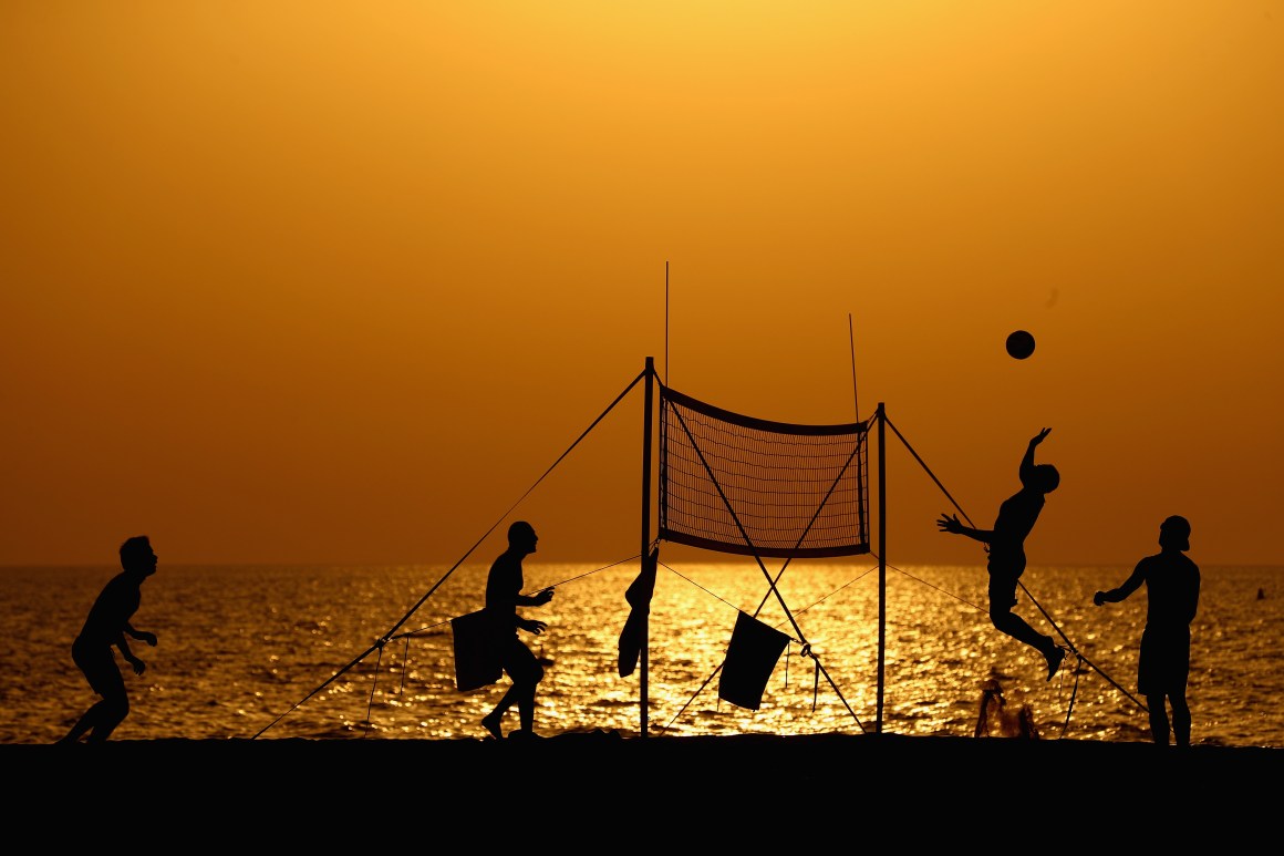 People play beach volleyball at Jumeirah Beach on August 3rd, 2017, in Dubai, United Arab Emirates.