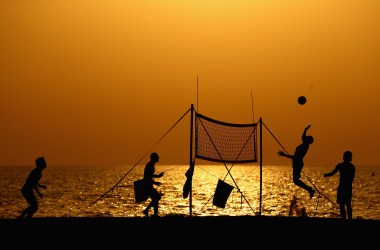 People play beach volleyball at Jumeirah Beach on August 3rd, 2017, in Dubai, United Arab Emirates.