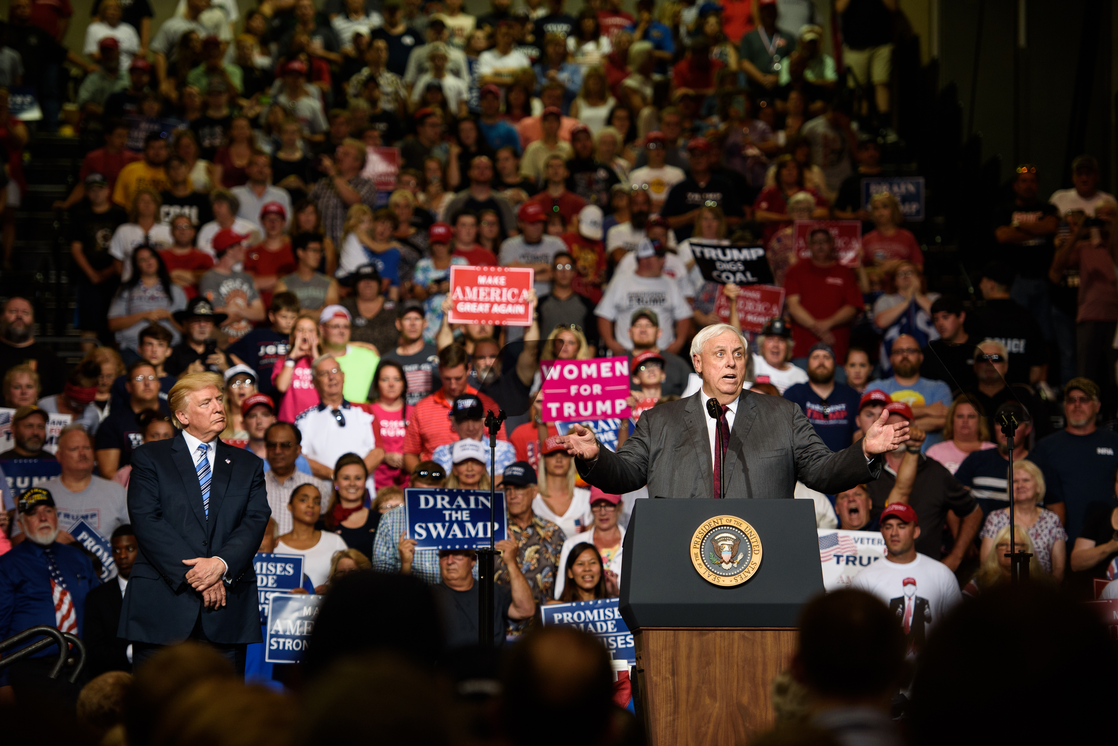 West Virginia Governor Jim Justice announces that he is switching parties to become a republican as President Donald J. Trump listens on at a campaign rally at the Big Sandy Superstore Arena on August 3rd, 2017, in Huntington, West Virginia.