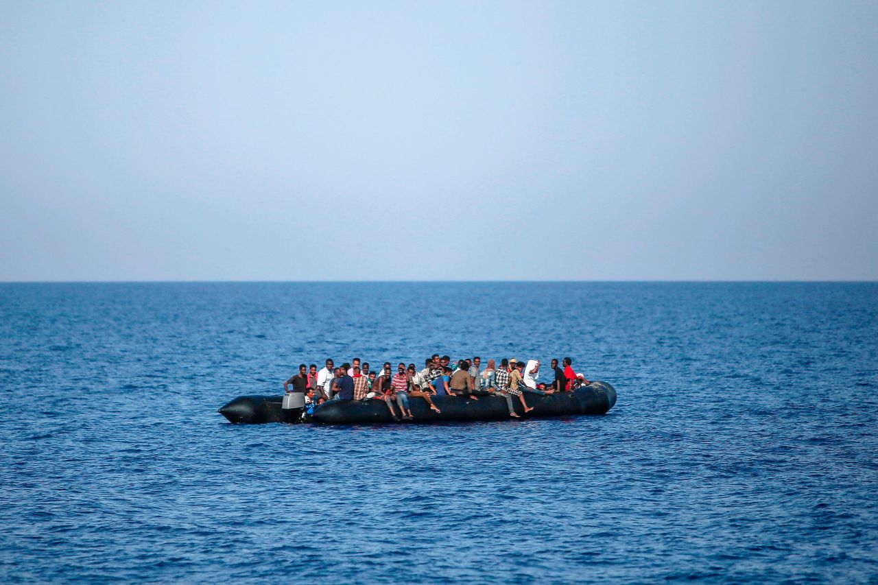 Migrants wait to be rescued by Italian coast guard in the Mediterranean Sea, 30 nautical miles from the Libyan coast, on August 6th, 2017.