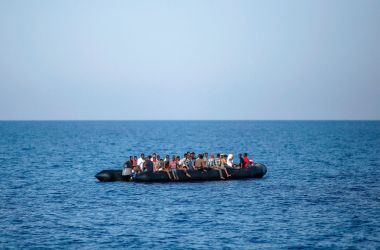 Migrants wait to be rescued by Italian coast guard in the Mediterranean Sea, 30 nautical miles from the Libyan coast, on August 6th, 2017.