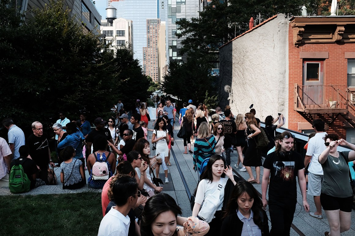 People enjoy a summer afternoon along the High Line in lower Manhattan on August 10th, 2017, in New York City.