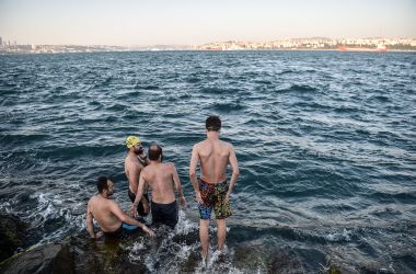 Migrants walk next to the Roya River on August 8th, 2017, in Ventimiglia, close to the French border.