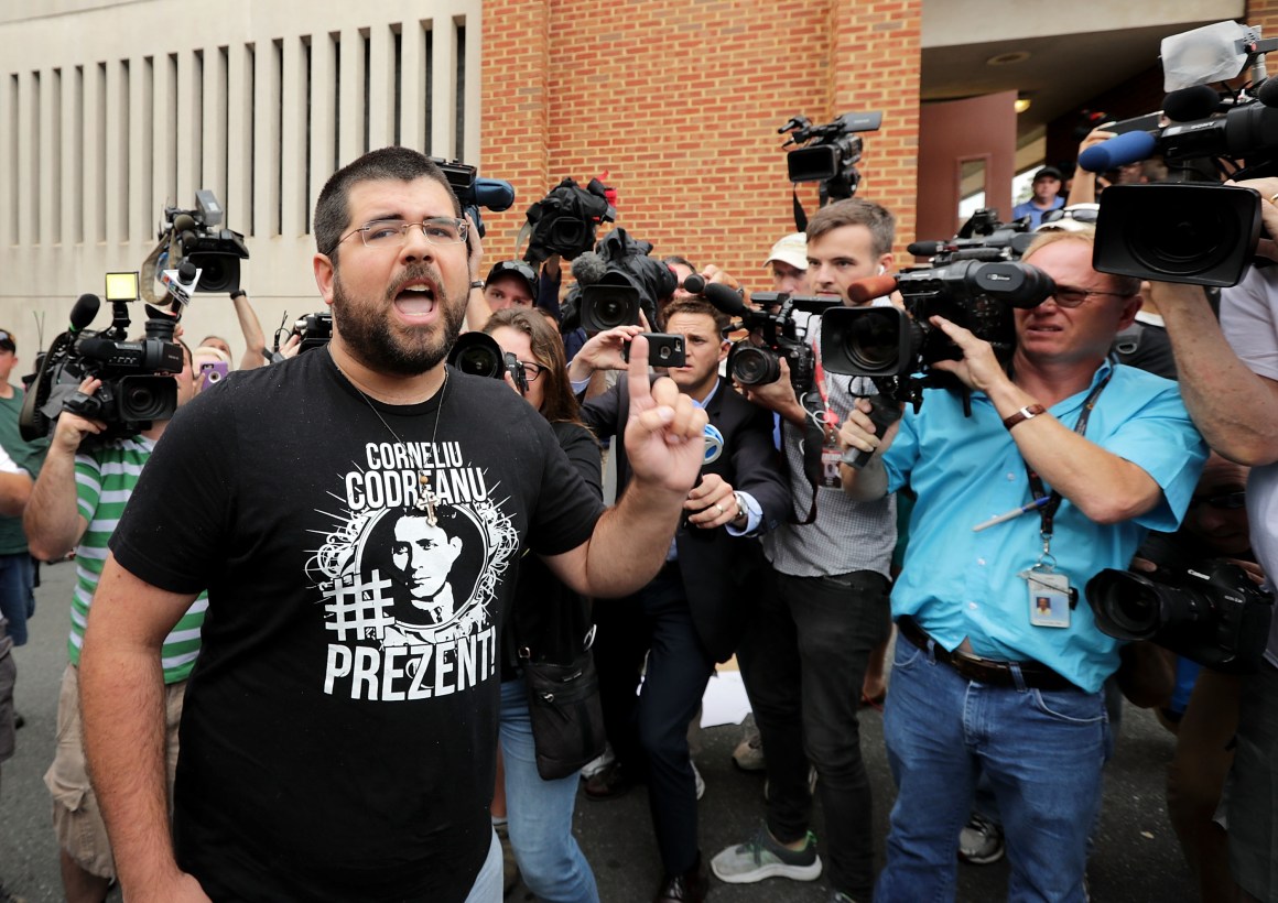 Matthew Heinbach (L) of the white nationalist Traditionalist Workers Party shouts at journalists gathered outside the Charlottesville General District Court building on August 14th, 2017, in Charlottesville, Virginia.