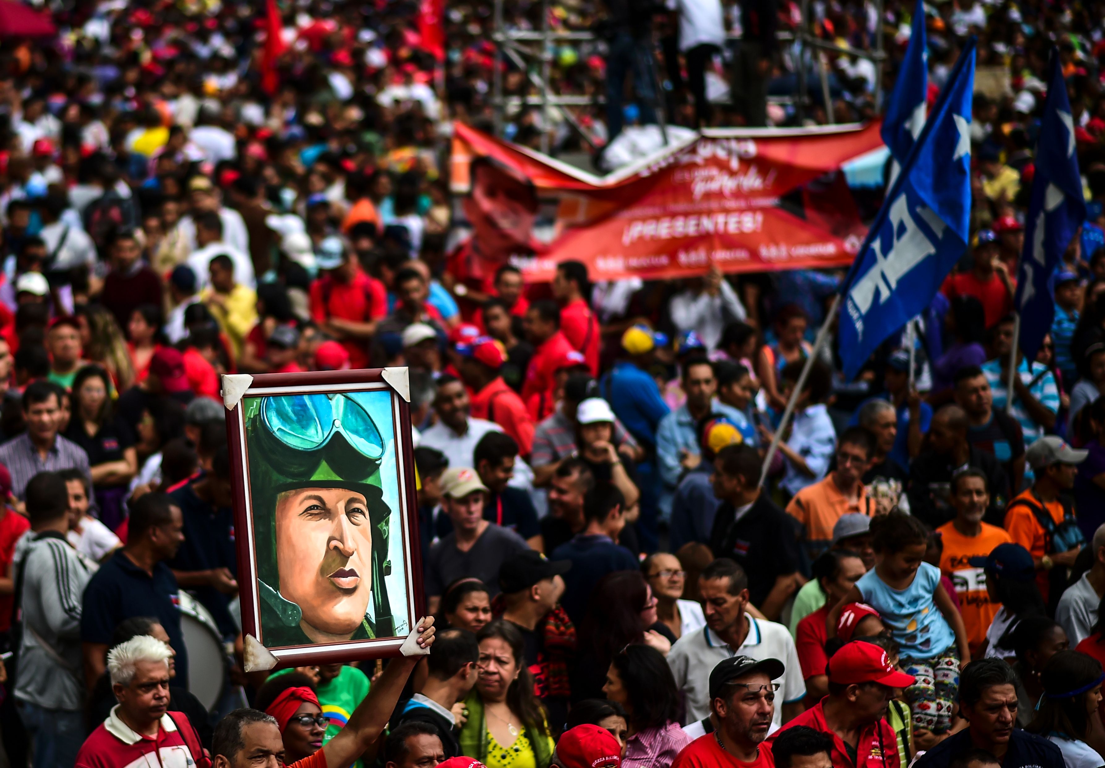 A pro-government activist holds a portrait depicting late Venezuelan President Hugo Chavez during a demonstration to show their support for the government of President Nicolás Maduro in Caracas, Venezuela, on August 14th, 2017.