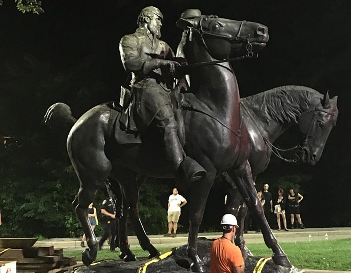 Workers load statues of Confederate generals Robert E. Lee and Thomas 'Stonewall' Jackson on a flatbed truck in the early hours of August 16th, 2017, in Baltimore, Maryland.