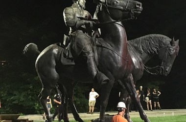 Workers load statues of Confederate generals Robert E. Lee and Thomas 'Stonewall' Jackson on a flatbed truck in the early hours of August 16th, 2017, in Baltimore, Maryland.