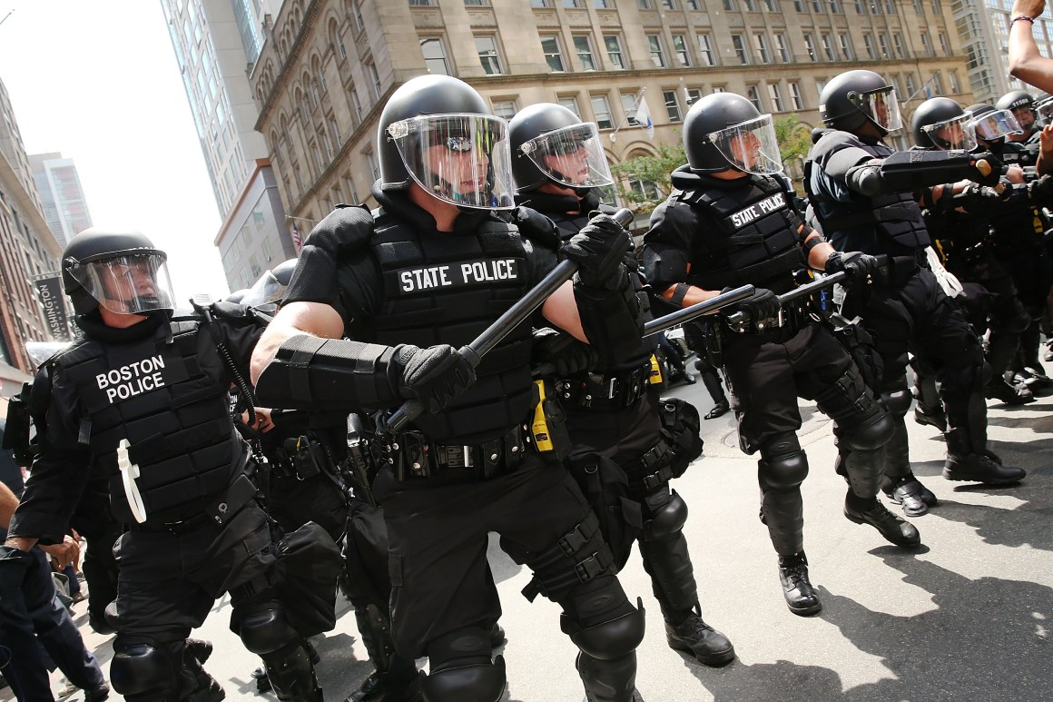 Protesters face off with riot police escorting conservative activists following a march in Boston against a planned "Free Speech Rally" just one week after the violent "Unite the Right" rally in Virginia left one woman dead and dozens more injured.