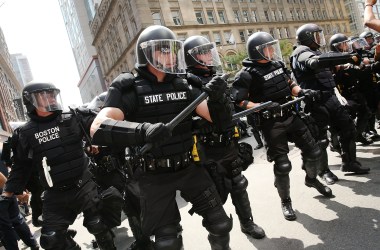 Protesters face off with riot police escorting conservative activists following a march in Boston against a planned "Free Speech Rally" just one week after the violent "Unite the Right" rally in Virginia left one woman dead and dozens more injured.