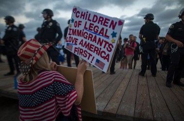 A demonstrator holds a sign during an America First rally on August 20th, 2017, in Laguna Beach, California.