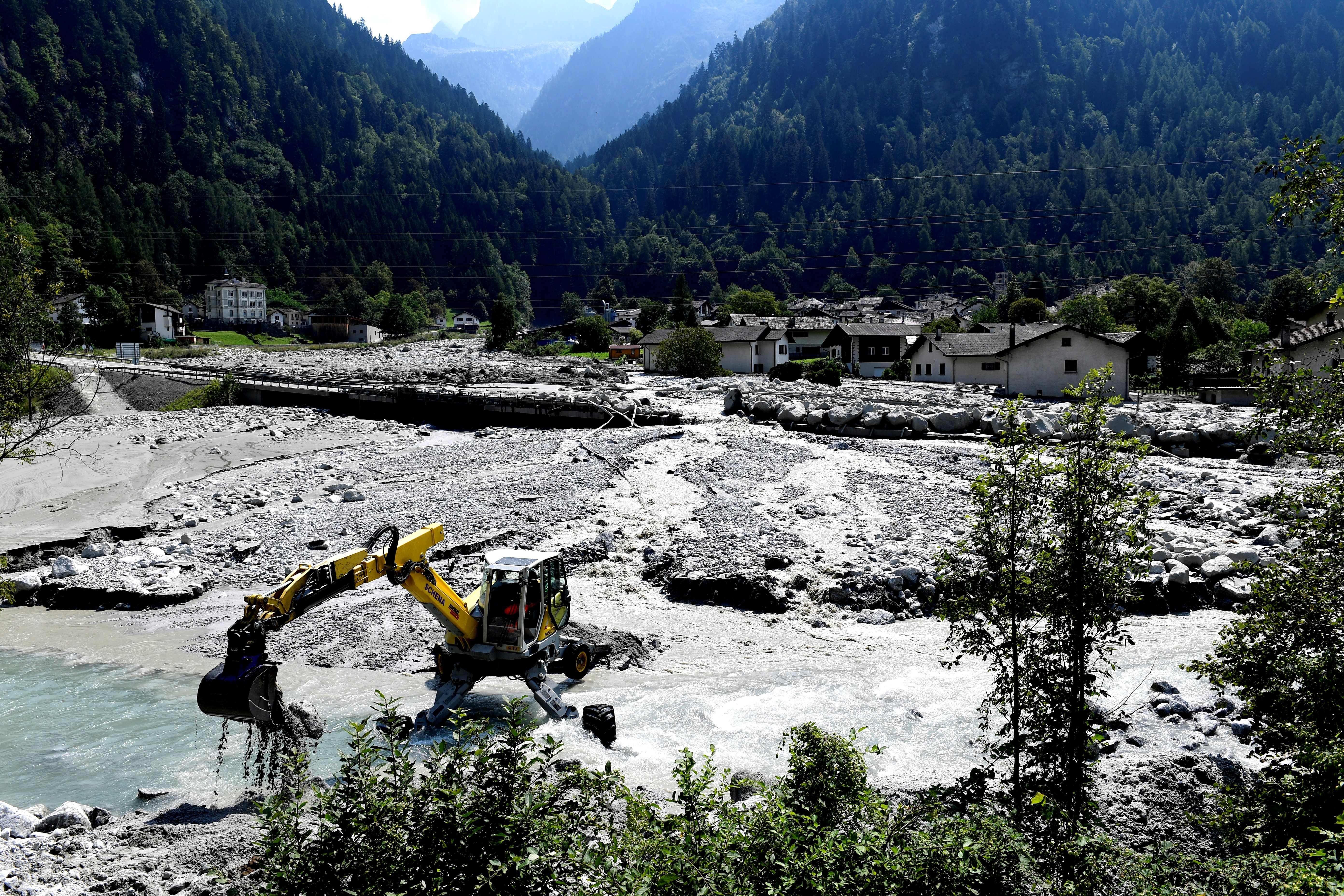 A digger clears rocks and debris on the outskirts of the village of Bondo in the Swiss Alps following a landslide on August 25th, 2017.