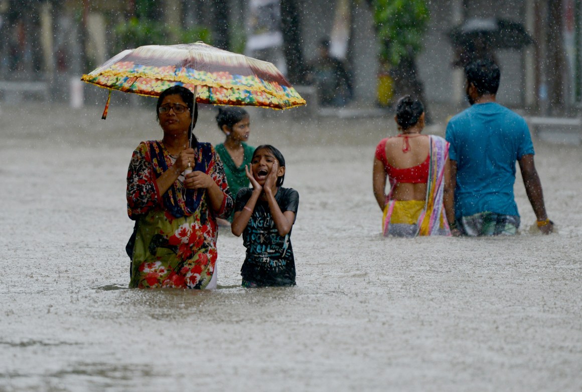 People wade through a flooded street in Mumbai, India, on August 29th, 2017.