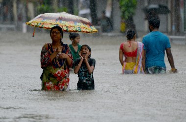 People wade through a flooded street in Mumbai, India, on August 29th, 2017.