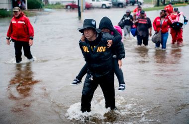 People walk to a Harris County Sheriff air boat while escaping a flooded neighborhood during the aftermath of Hurricane Harvey on August 29th, 2017, in Houston, Texas. Hurricane Harvey has set what forecasters believe is a new rainfall record for the continental United States, officials said Tuesday.