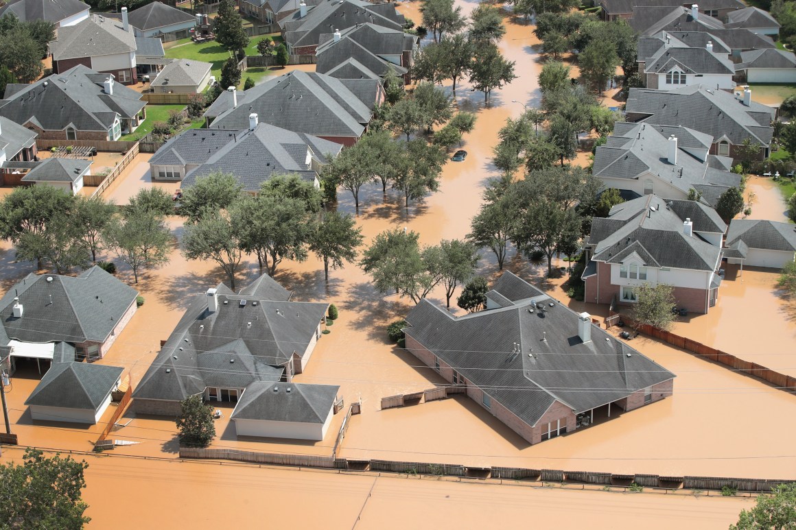 Homes are surrounded by floodwater after torrential rains pounded Southeast Texas.