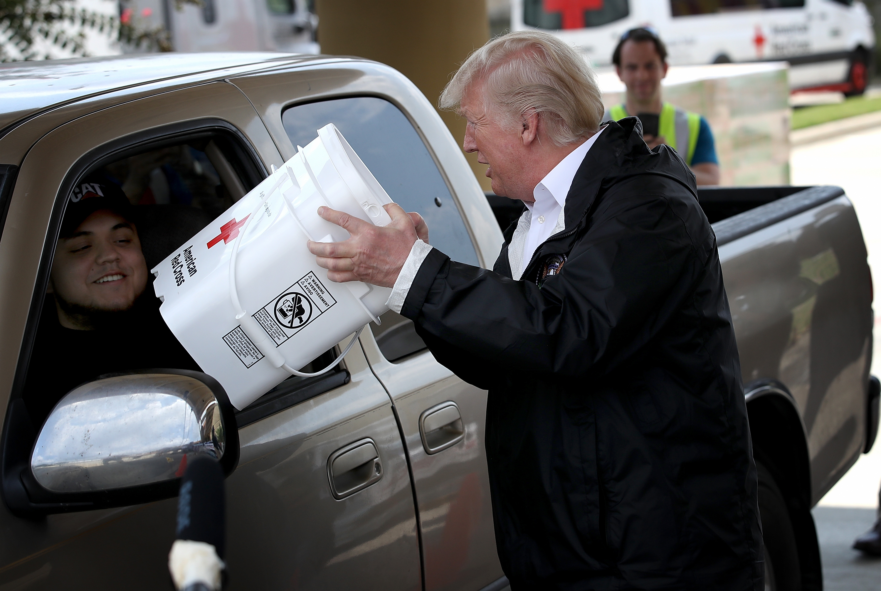 President Donald Trump attempts to help move emergency supplies during Hurricane Harvey in Pearland, Texas, on September 2nd, 2017.