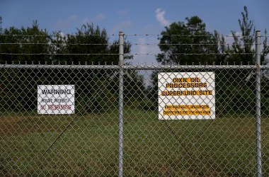 A sign is posted on a fence at the Dixie Oil Processors Superfund site on September 4th, 2017, in Friendswood, Texas.