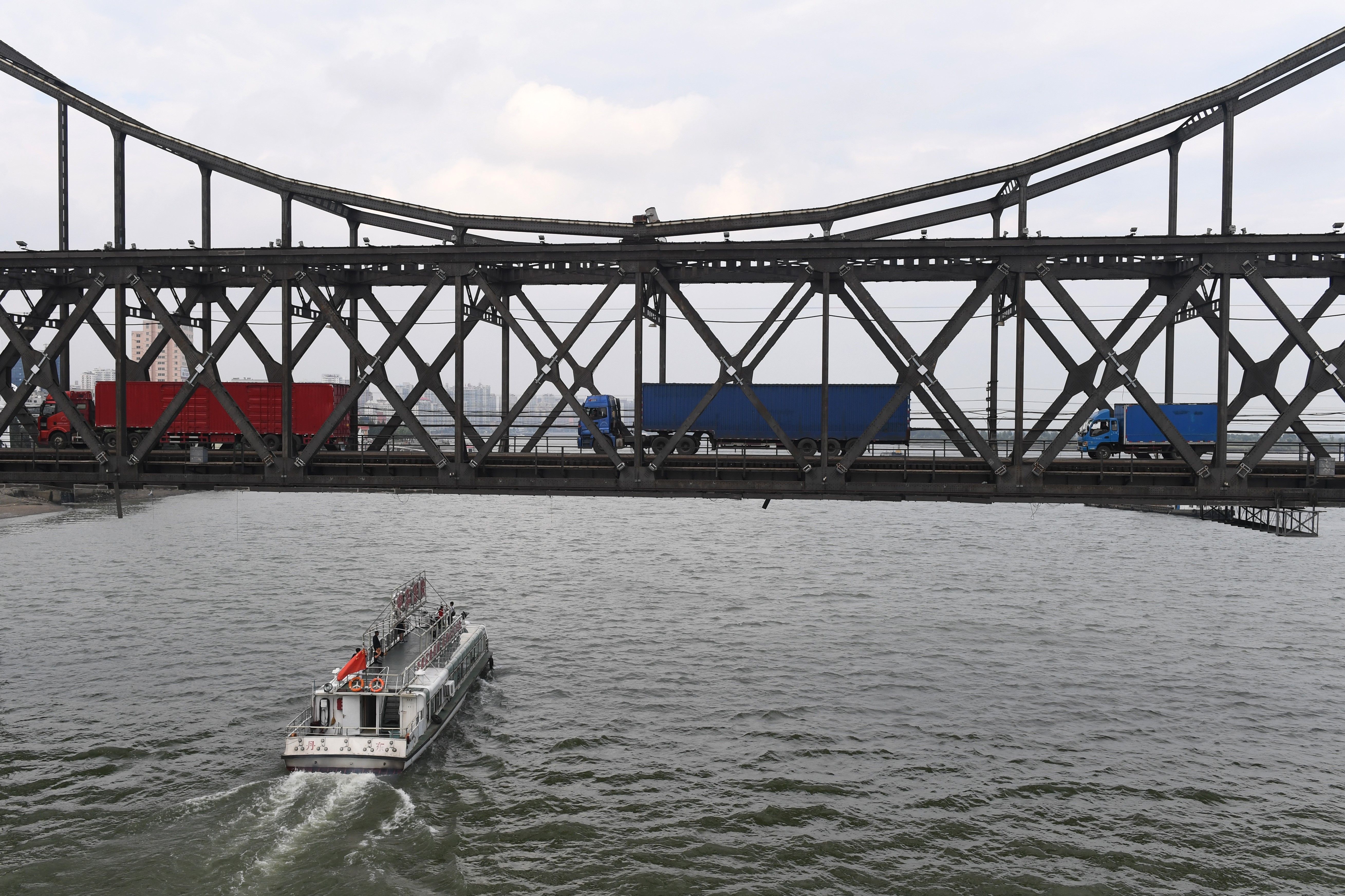 Trucks return over the Friendship Bridge, from the North Korean town of Sinuiju to the Chinese border city of Dandong, on September 5th, 2017.