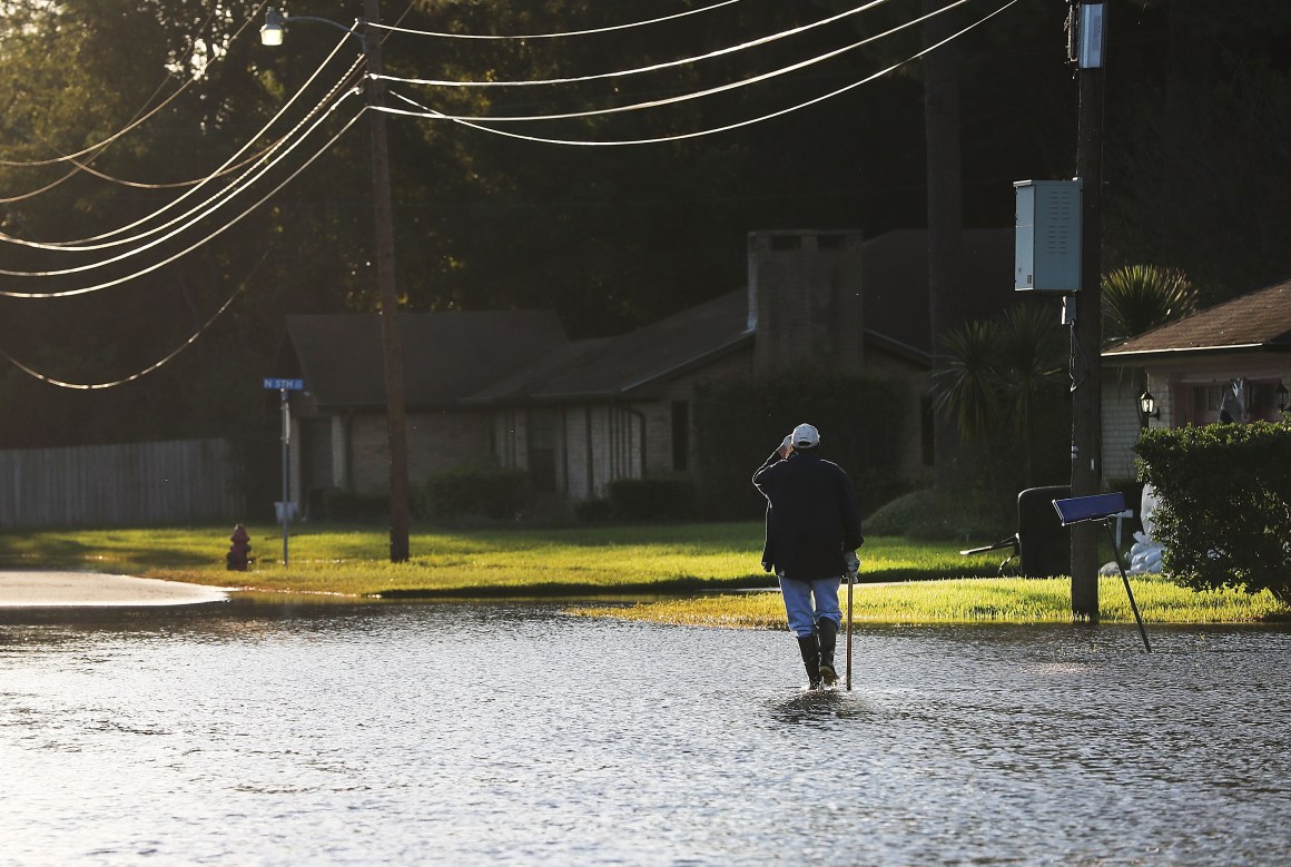 A man walks through his neighborhood in Orange, Texas, on September 7th, 2017.