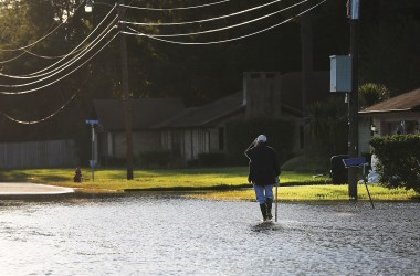 A man walks through his neighborhood in Orange, Texas, on September 7th, 2017.