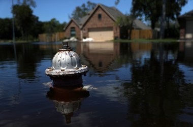 The top of a fire hydrant sticks out of floodwaters in front of a home on September 7th, 2017, in Richwood, Texas.