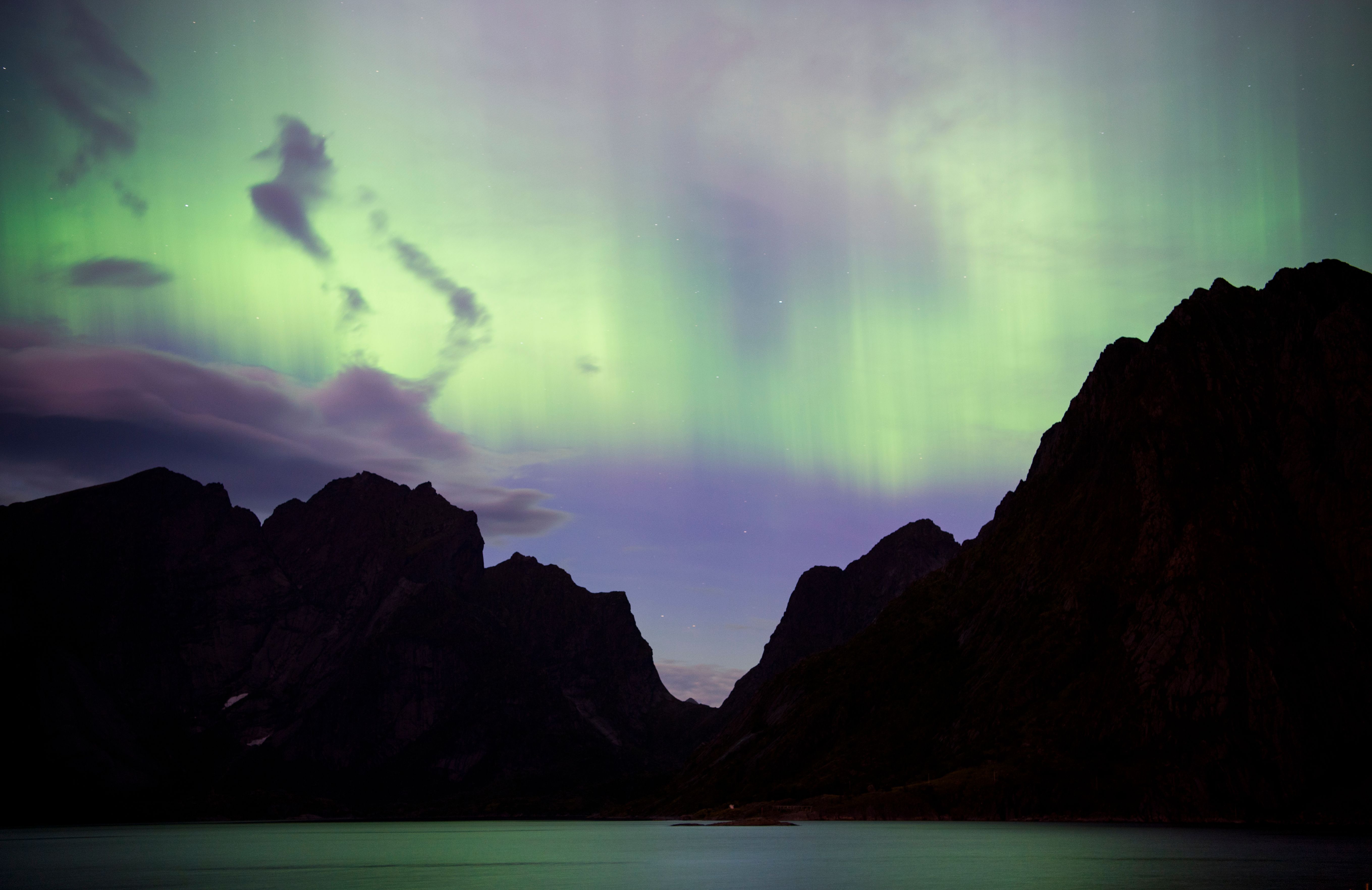 Northern lights (aurora borealis) illuminate the sky over Reinfjorden in Reine, on Lofoten Islands, Arctic Circle, on September 8th, 2017.