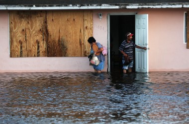 A couple leave their flooded home the morning after Hurricane Irma swept through the area on September 11th, 2017, in Fort Myers, Florida.