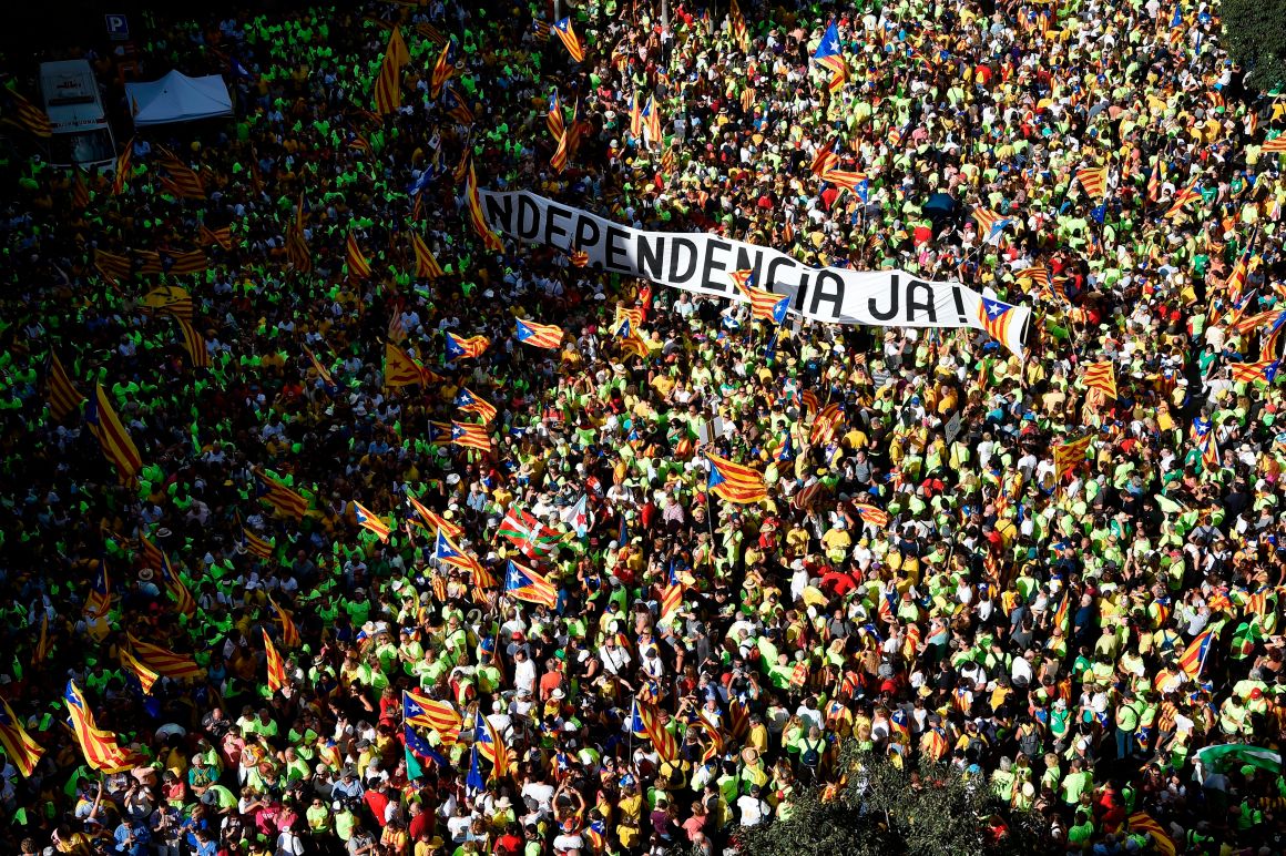 People hold a banner reading "Independence now!" in Catalan as they gather during a pro-independence demonstration, on September 11th, 2017, in Barcelona during the National Day of Catalonia. Hundreds of thousands of Catalans were expected to rally to demand their region break away from Spain in a show of strength three weeks ahead of a secession referendum banned by Madrid. The protest coincides with Catalonia's national day, the "Diada," which commemorates the fall of Barcelona in the War of the Spanish Succession in 1714 and the region's subsequent loss of institutions and freedoms.