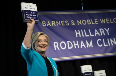 Former U.S. Secretary of State Hillary Clinton holds up a copy of her new book What Happened at a book signing event at a Barnes and Noble bookstore on September 12th, 2017, in New York City.