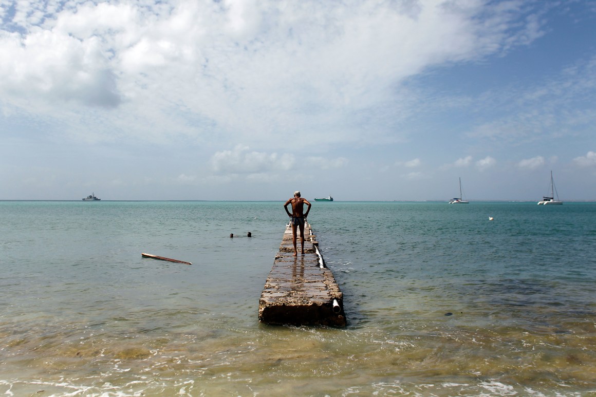 A man stands on a damage pier days after this Caribbean island sustained extensive damage in the wake of Hurricane Irma on September 15th, 2017, in St. Martin.