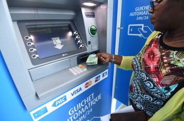 A woman uses an Ecobank Ivory Coast cash dispenser on September 18th, 2017.